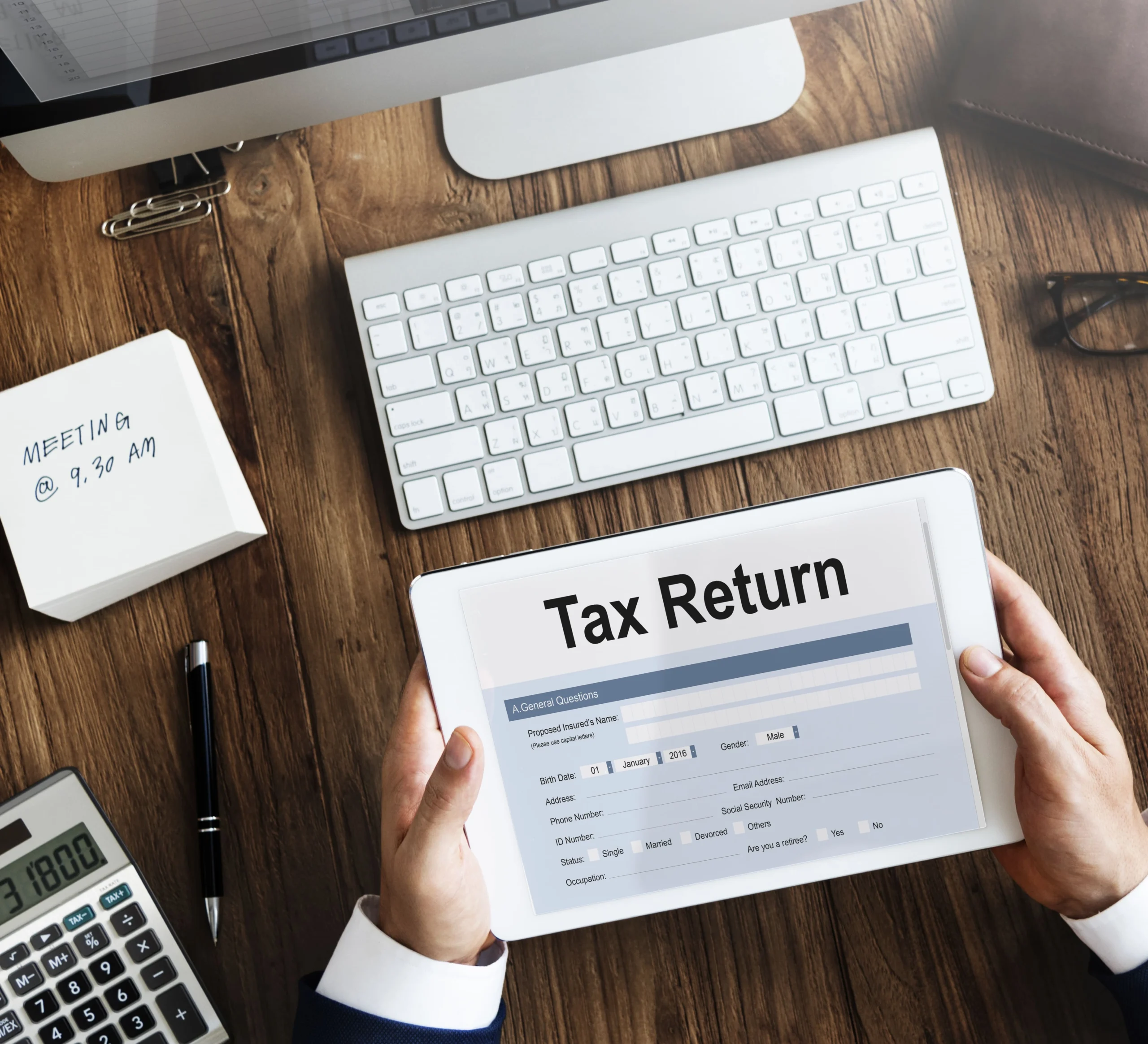 Accountant reviewing GST forms and receipts, representing Wio Accounting’s professional GST filing and compliance services for businesses in British Columbia.